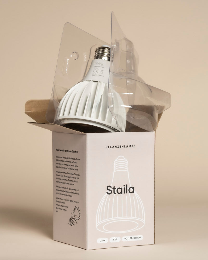 Eine Pflanzenlampe, die für Zimmerpflanzen bestimmt ist, wird teilweise aus einem 